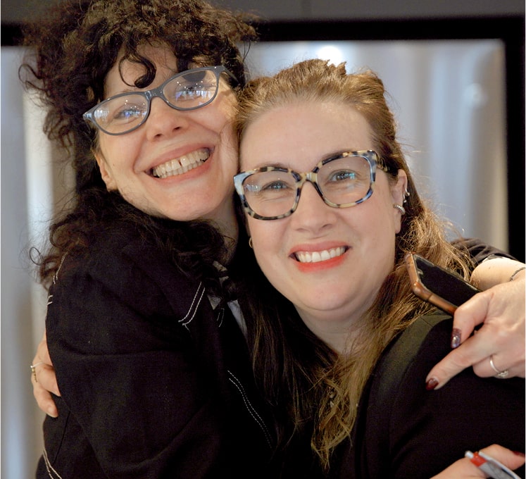two female colleagues hugging