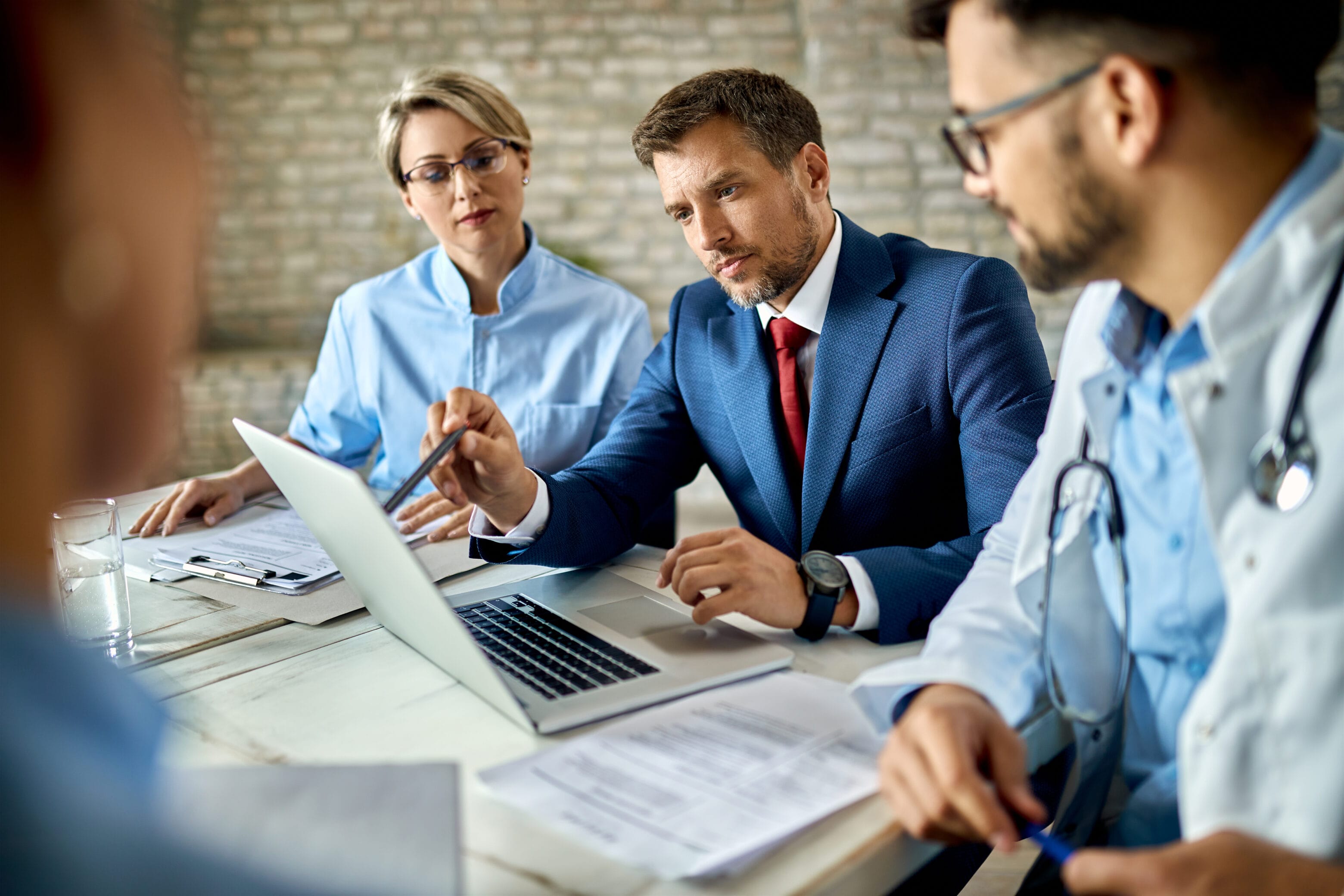 Diverse healthcare IT team reviewing digital dashboard