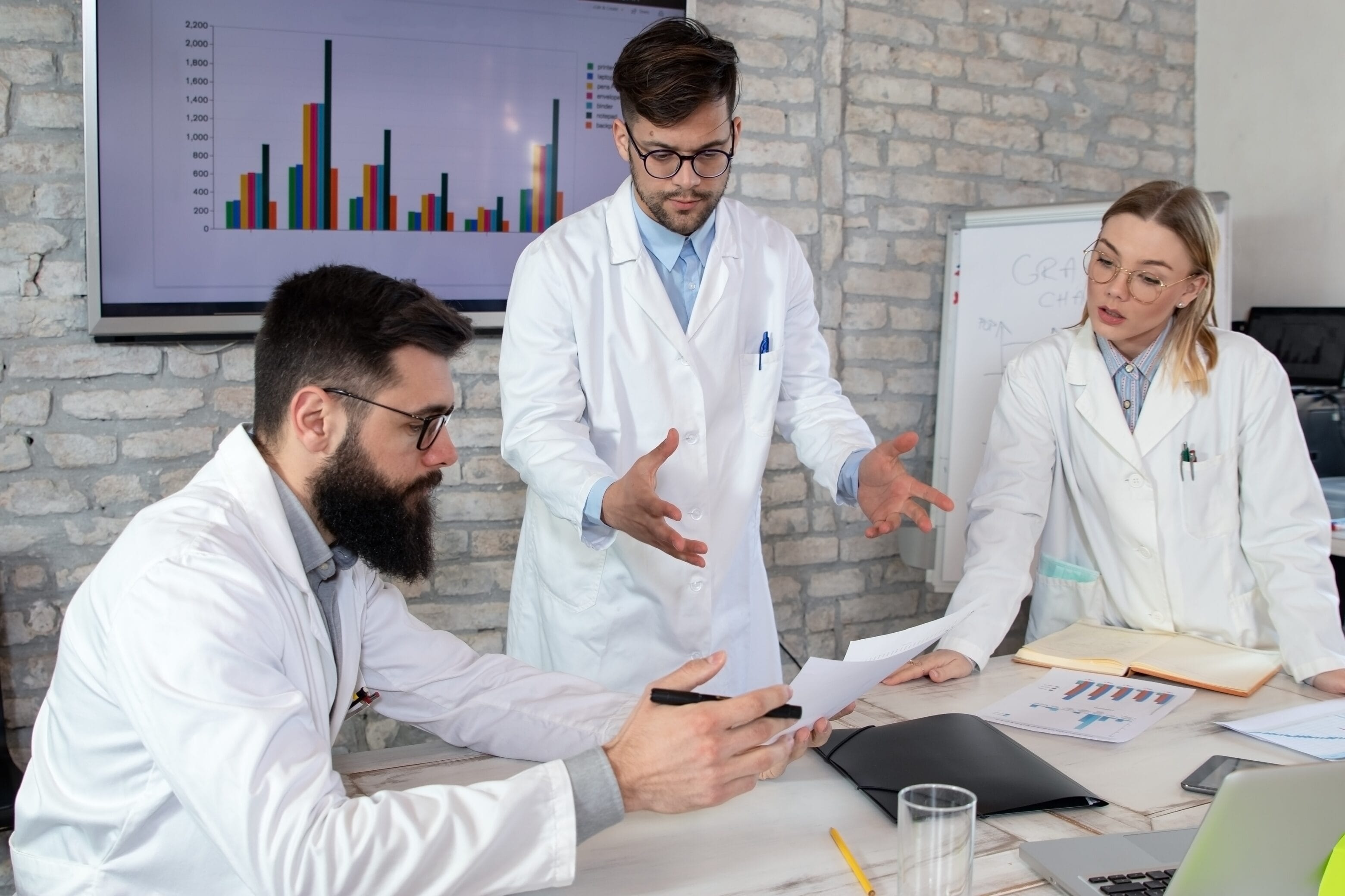 Group of doctors discussing possible solutions for resolving Covid-19 world health crisis